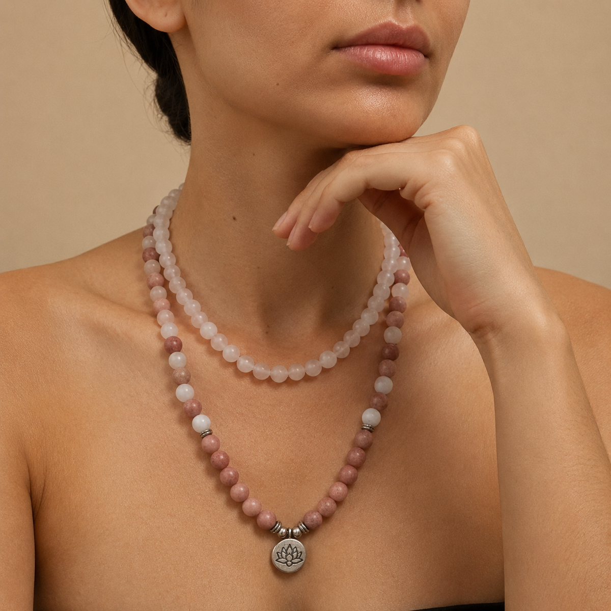 Soft Bloom Necklace worn at the neckline, with pink round stone beads and a small round charm