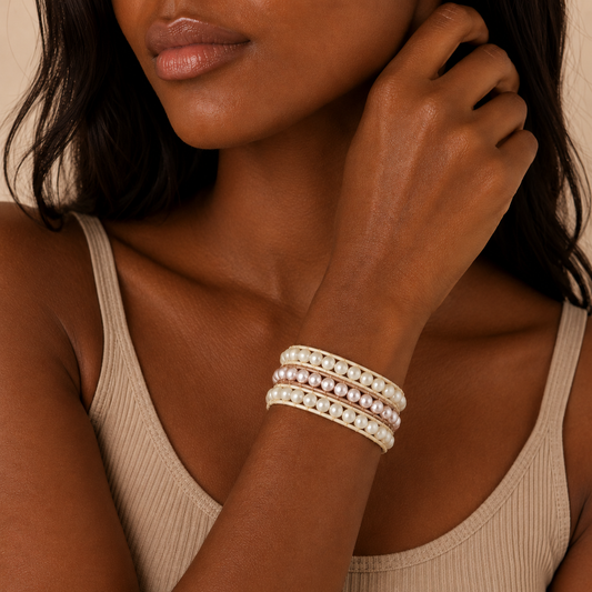 Soft Bond Bracelet worn on the wrist, with layered cream and pearl-like round beads