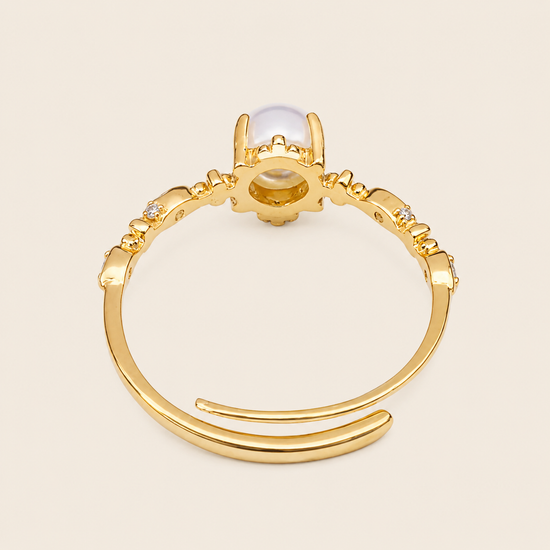 Soft Moon Ring with a pale blue round centre stone and small floral accents in gold finish