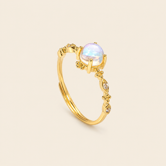Soft Moon Ring with a pale blue round centre stone and small floral accents in gold finish