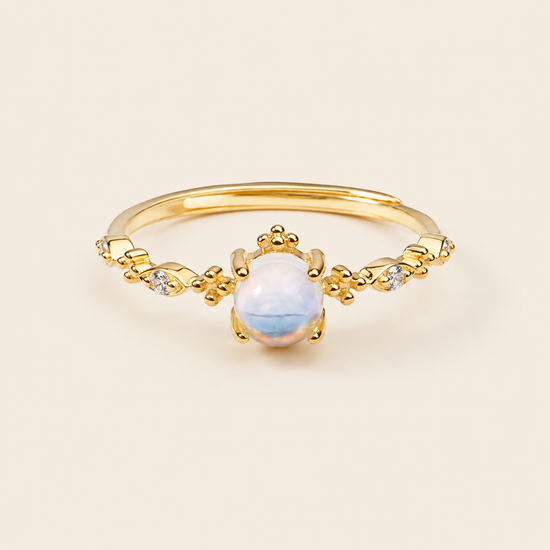 Soft Moon Ring with a pale blue round centre stone and small floral accents in gold finish