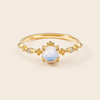 Soft Moon Ring with a pale blue round centre stone and small floral accents in gold finish