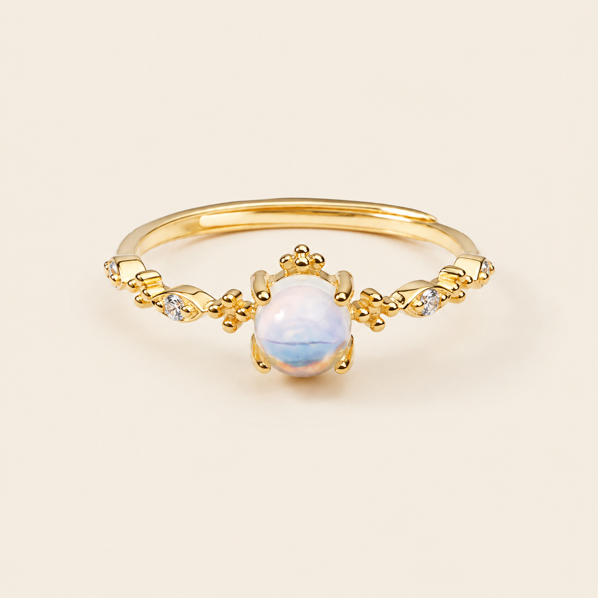 Soft Moon Ring with a pale blue round centre stone and small floral accents in gold finish