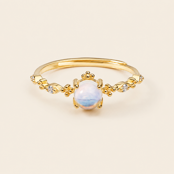 Soft Moon Ring with a pale blue round centre stone and small floral accents in gold finish