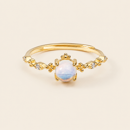 Soft Moon Ring with a pale blue round centre stone and small floral accents in gold finish