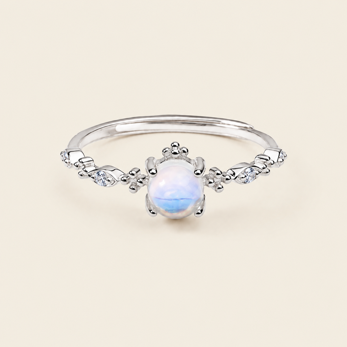 Soft Moon Ring with a pale blue round centre stone and small floral accents in silver finish
