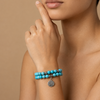 Solara Tree Bracelet worn on the wrist, with turquoise-coloured round beads and a tree motif charm