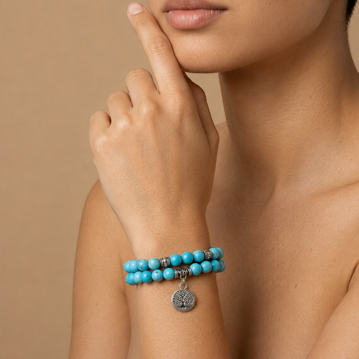 Solara Tree Bracelet worn on the wrist, with turquoise-coloured round beads and a tree motif charm