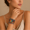Spectrum Heart Bracelet worn on the wrist, with layered multicoloured beads and a heart centre