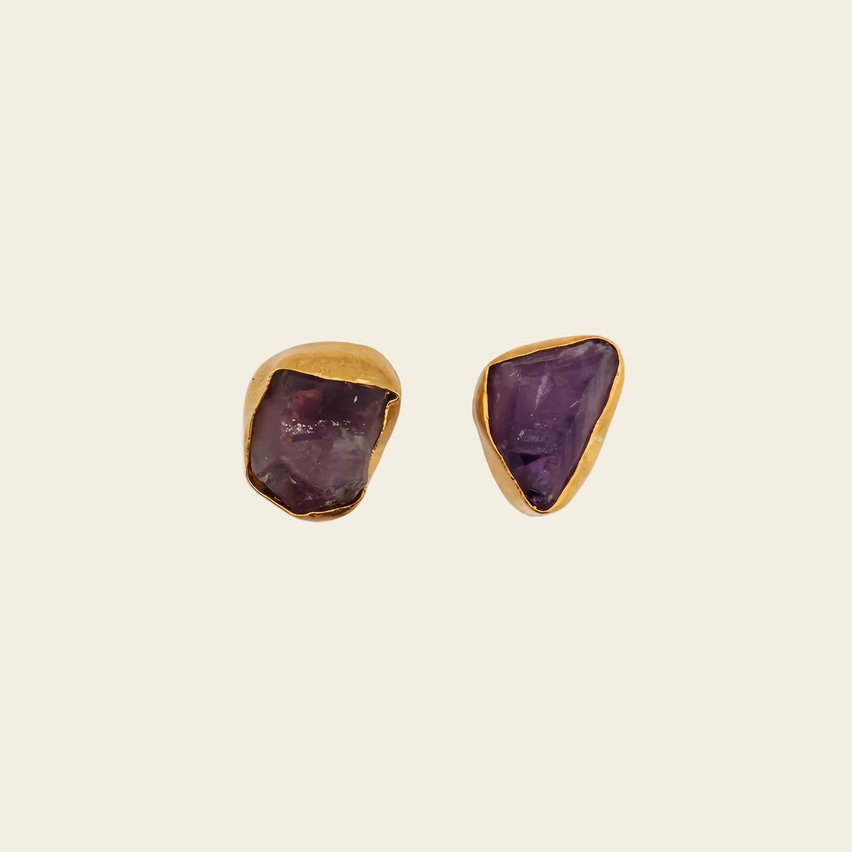 Still Core Earrings with irregular purple stone studs with gold-coloured edges