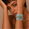 Still Current Bracelet worn on the wrist, with layered green and pale stone beads