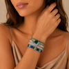 Still Pattern Bracelet worn on the wrist, with layered pale, green and multicoloured beads