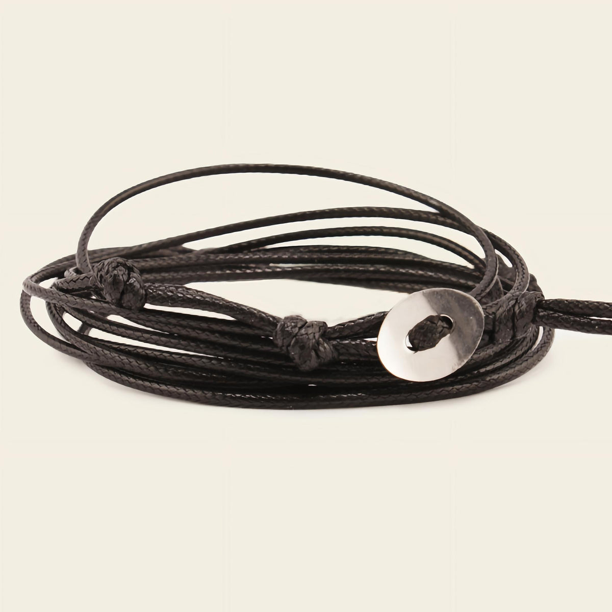 Stillwater Hold Bracelet with a turquoise-coloured stone centre on layered dark cord