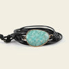 Stillwater Hold Bracelet with a turquoise-coloured stone centre on layered dark cord