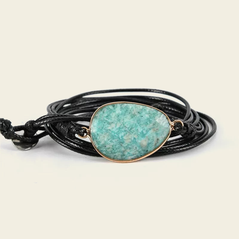 Stillwater Hold Bracelet with a turquoise-coloured stone centre on layered dark cord