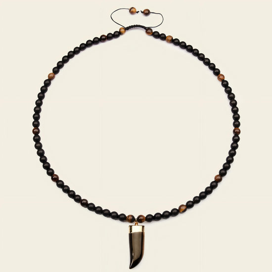Talon Drift Necklace with dark round beads and a claw-shaped pendant
