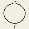 Talon Drift Necklace with dark round beads and a claw-shaped pendant