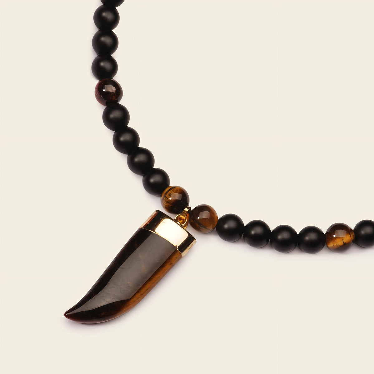 Talon Drift Necklace with dark round beads and a claw-shaped pendant