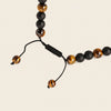 Talon Drift Necklace with dark round beads and a claw-shaped pendant