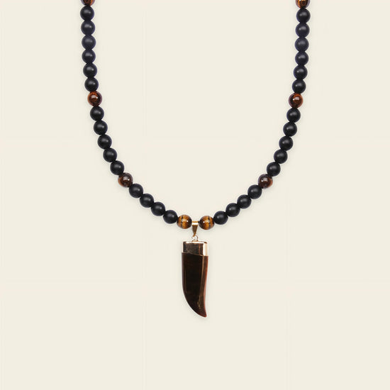 Talon Drift Necklace with dark round beads and a claw-shaped pendant
