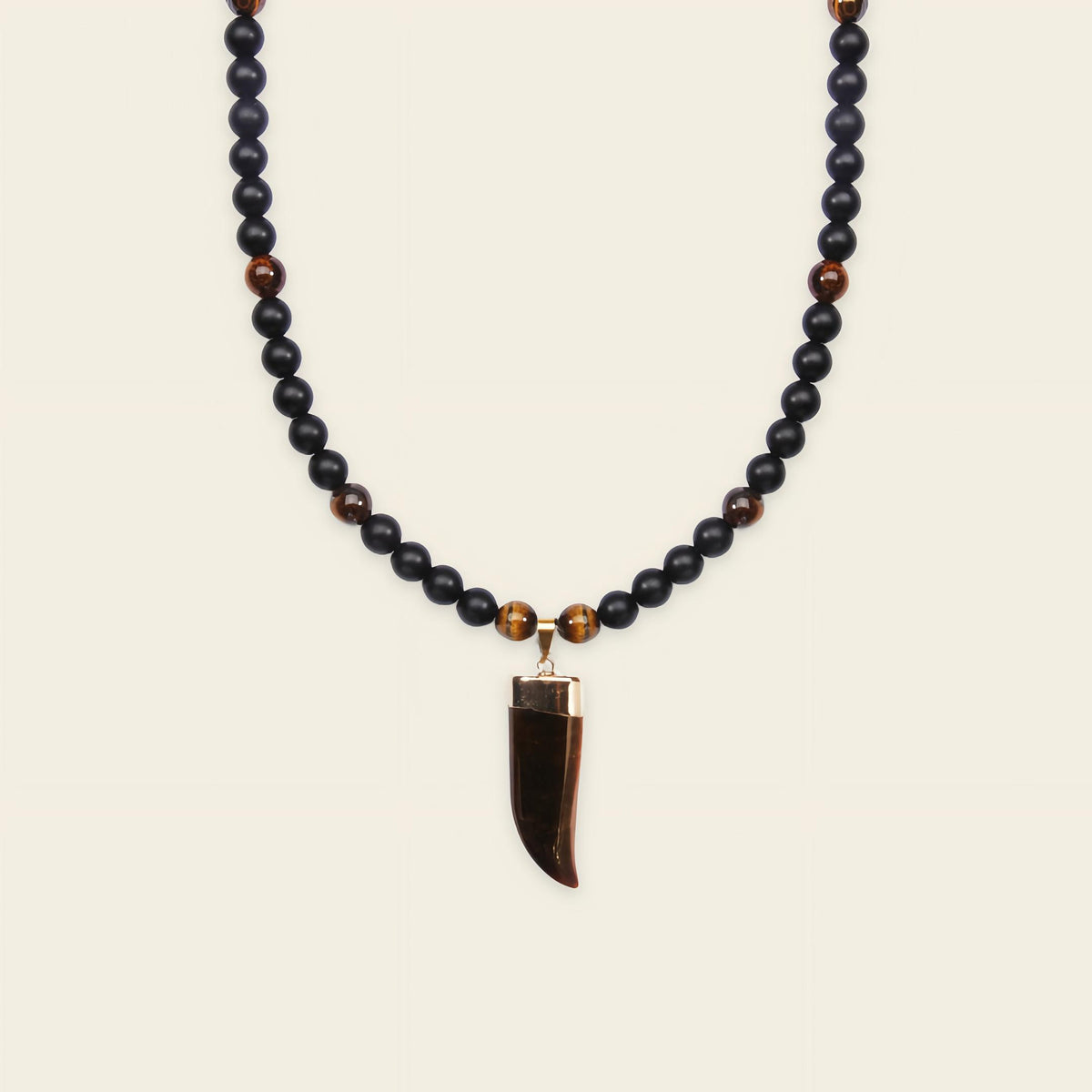 Talon Drift Necklace with dark round beads and a claw-shaped pendant