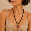 Talon Drift Necklace worn at the neckline, with dark round beads and a claw-shaped pendant