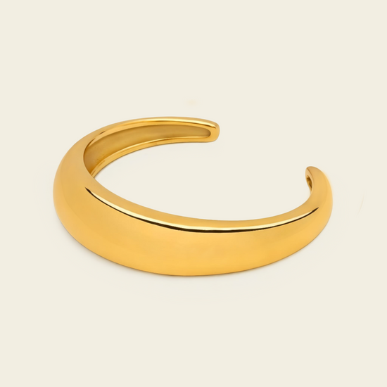 Tapered Arc Cuff with a smooth tapered open band in gold finish