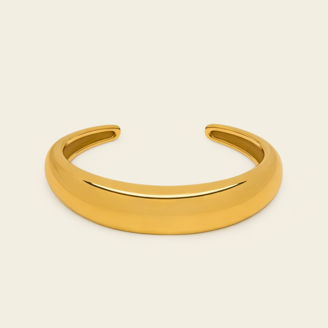 Tapered Arc Cuff with a smooth tapered open band in gold finish
