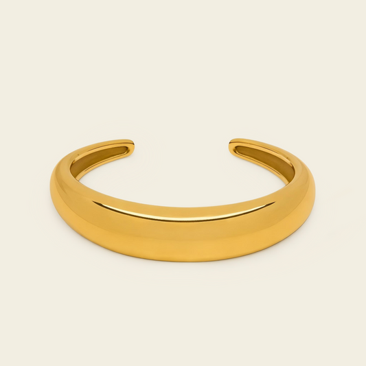 Tapered Arc Cuff with a smooth tapered open band in gold finish
