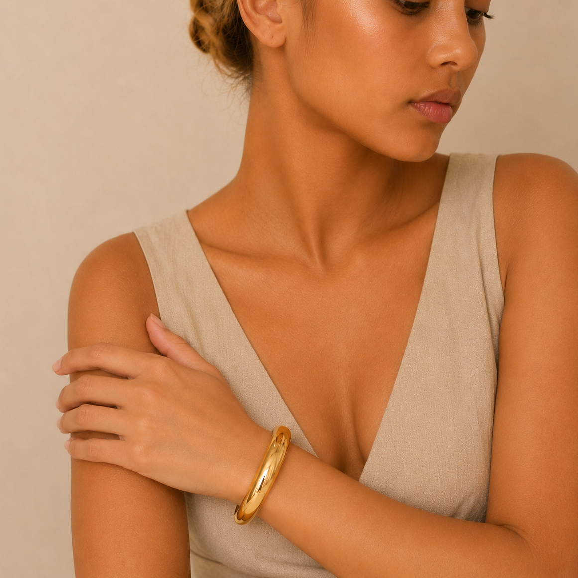 Tapered Arc Cuff worn on the wrist in gold finish