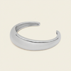Tapered Arc Cuff with a smooth tapered open band in silver finish
