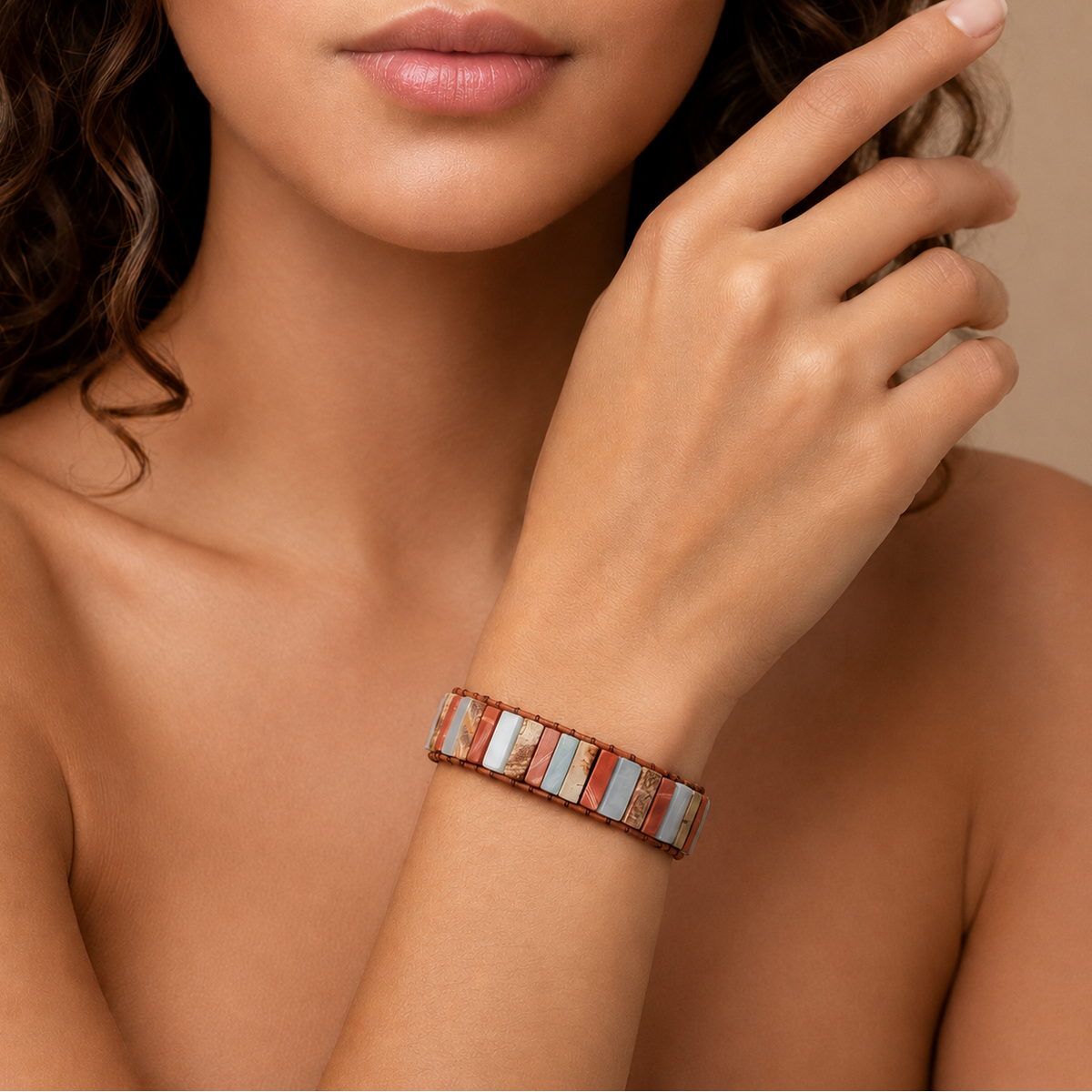 Terracline Tile Bracelet worn on the wrist, with red, cream and pale blue stone tiles