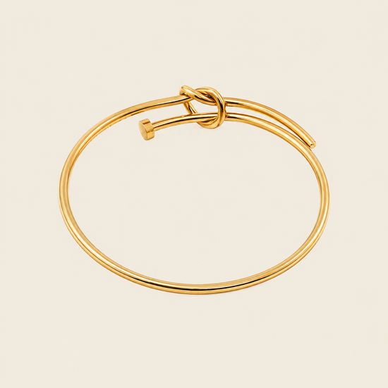Tied Line Bracelet with a fine open band with a central knot in gold finish