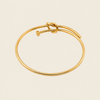 Tied Line Bracelet with a fine open band with a central knot in gold finish