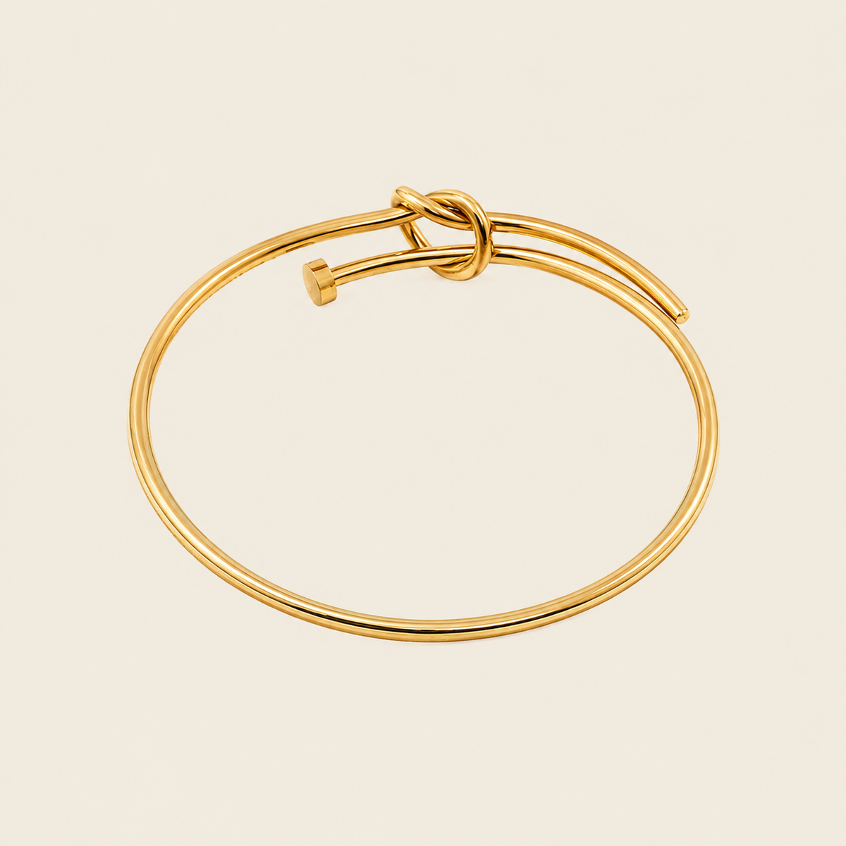 Tied Line Bracelet with a fine open band with a central knot in gold finish