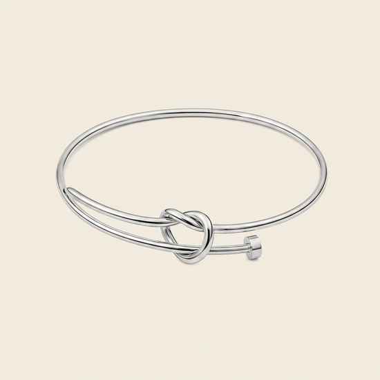 Tied Line Bracelet with a fine open band with a central knot in silver finish