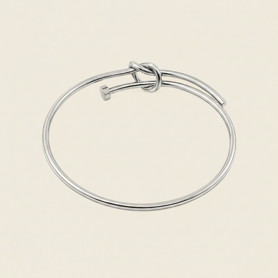 Tied Line Bracelet with a fine open band with a central knot in silver finish