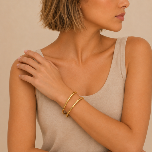 Twin Arc Cuff worn on the wrist in gold finish
