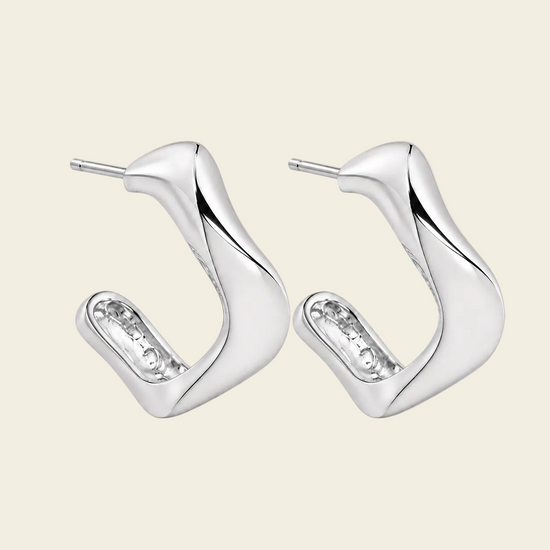 Twisted Ribbon Earrings with polished curved ribbon-shaped hoops in silver finish
