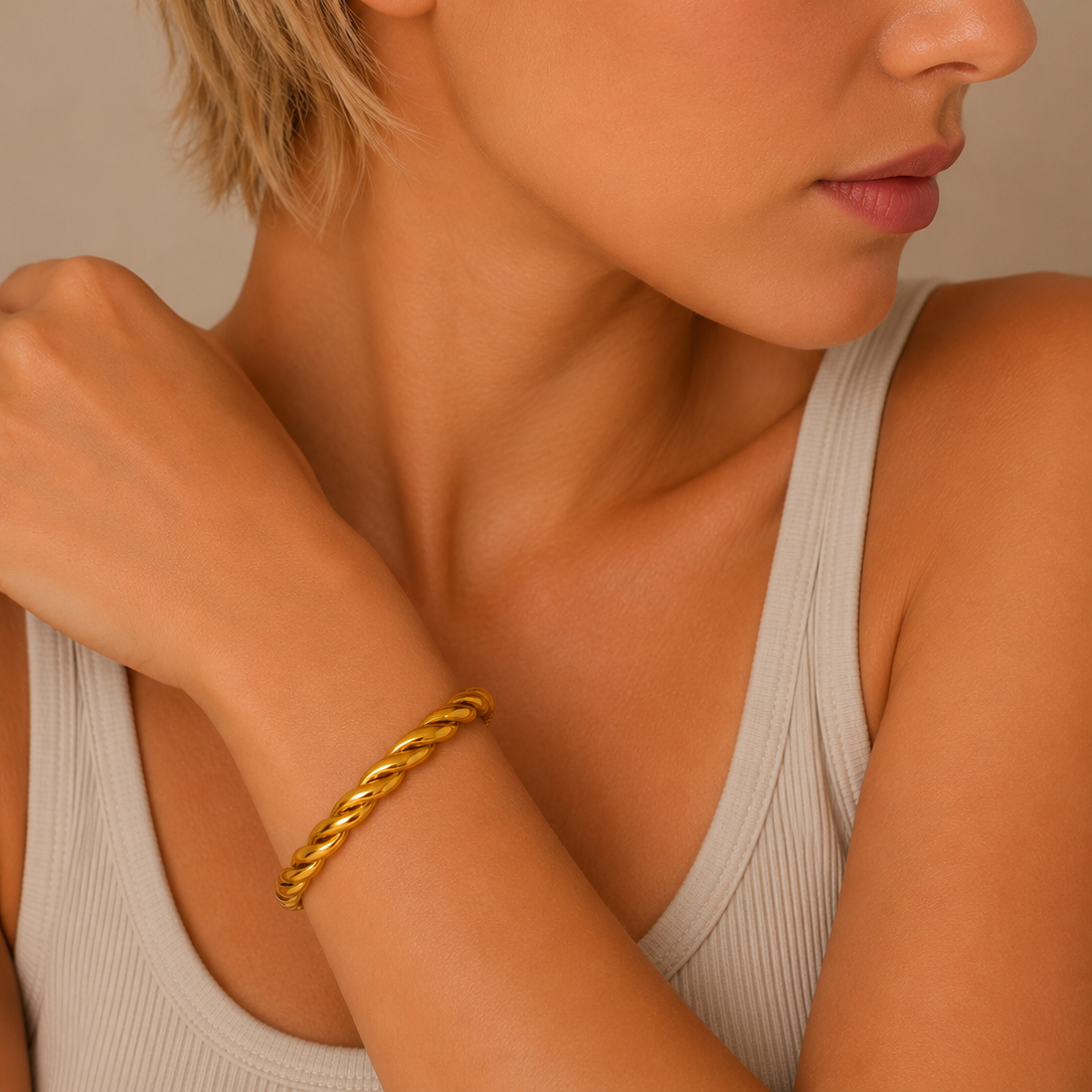 Twisted Strand Cuff worn on the wrist in gold finish