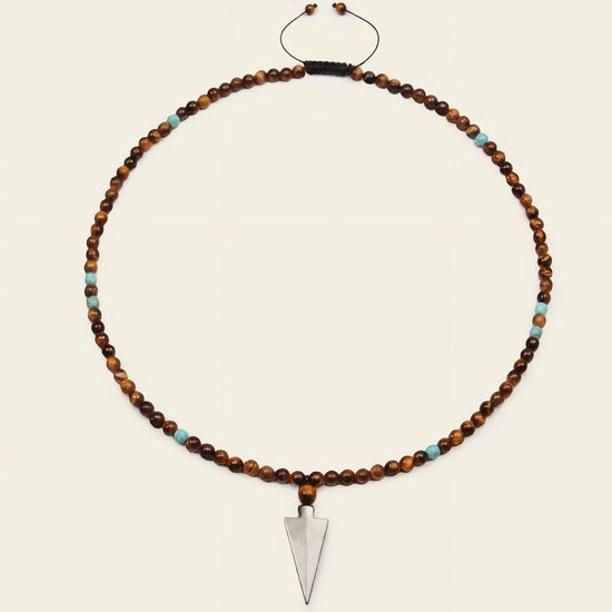 Vector Calm Necklace with brown stone beads and a pointed metal pendant