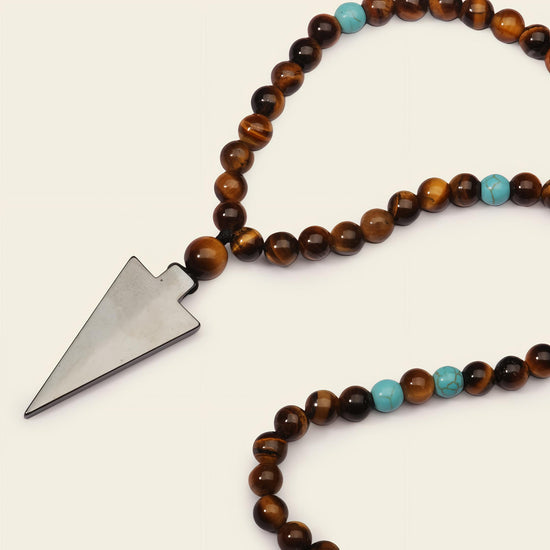 Vector Calm Necklace with brown stone beads and a pointed metal pendant