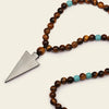 Vector Calm Necklace with brown stone beads and a pointed metal pendant