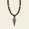 Vector Calm Necklace with brown stone beads and a pointed metal pendant