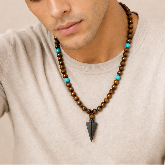 Vector Calm Necklace worn at the neckline, with brown stone beads and a pointed metal pendant