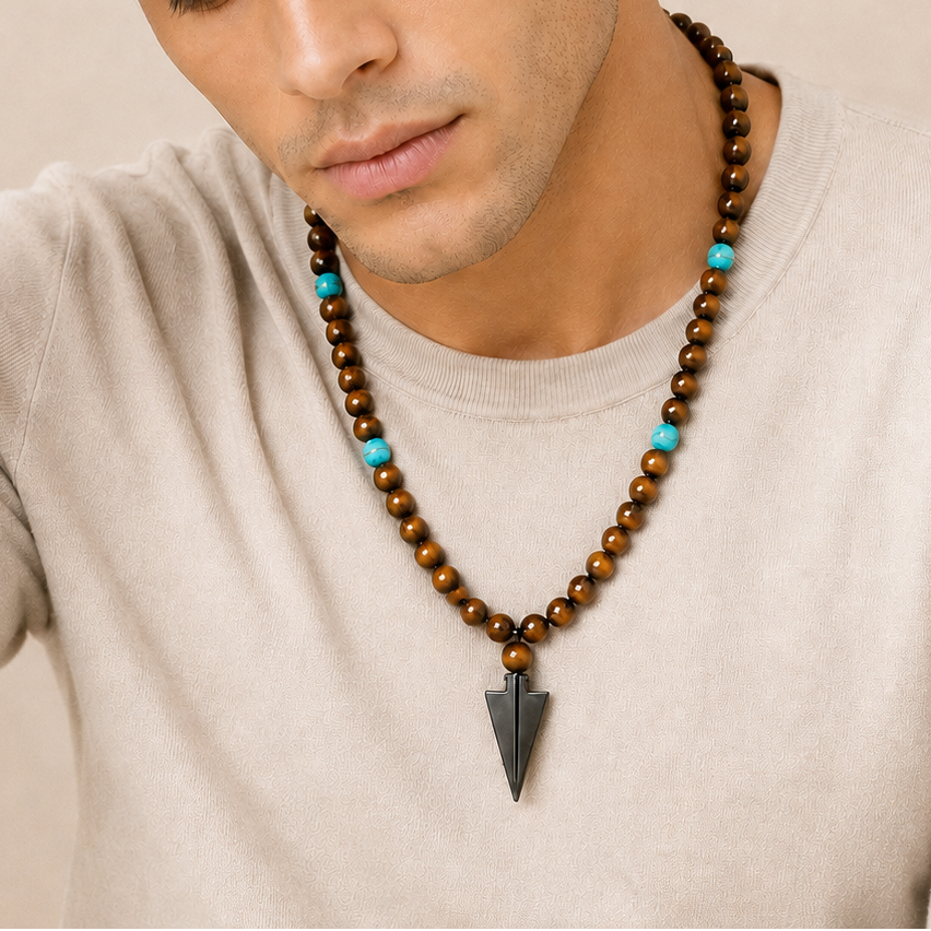 Vector Calm Necklace worn at the neckline, with brown stone beads and a pointed metal pendant