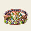 Forest Mosaic Bracelet with a green mosaic-patterned oval centre and layered beads