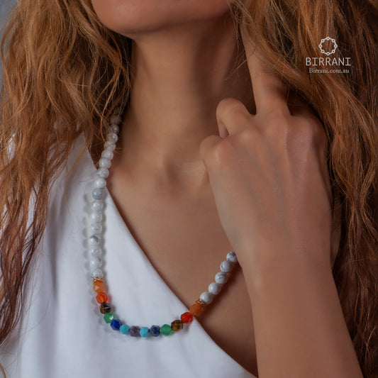 Spectrum Line Necklace worn at the neckline, with small round beads and multicoloured accents